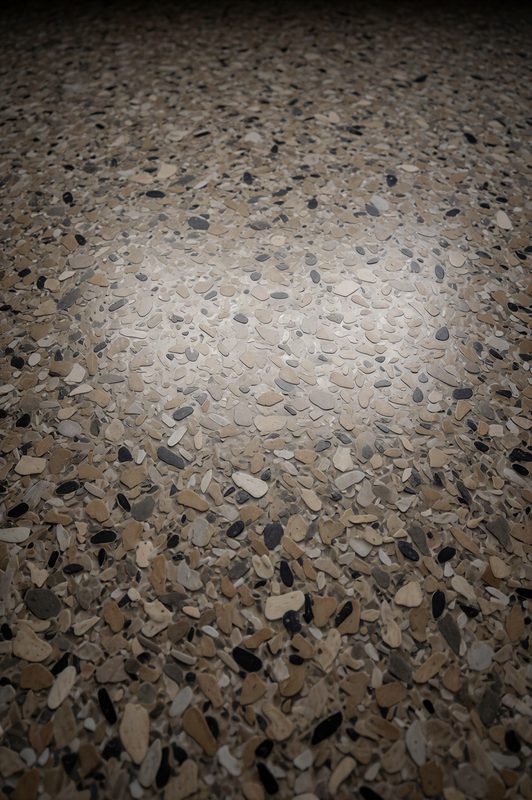 Close-up of a black, white and gray decorative flake floor finish
